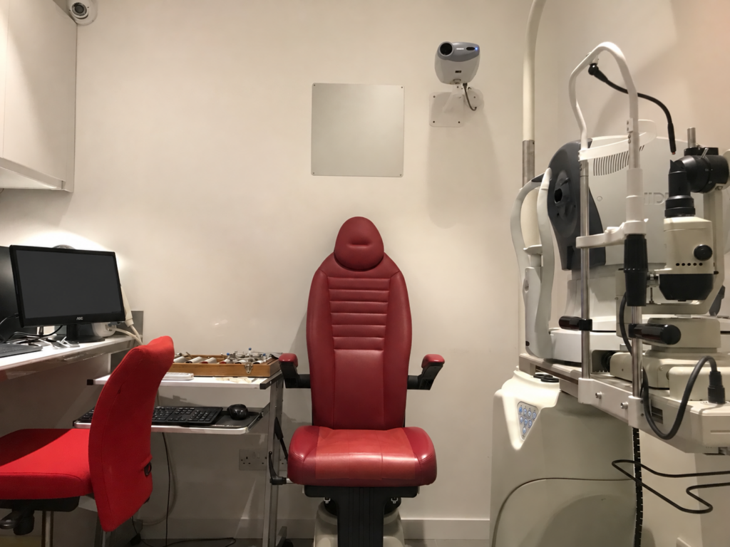 Consulting room at Specs Direct Barnet with a red examination chair and eye examination equipment